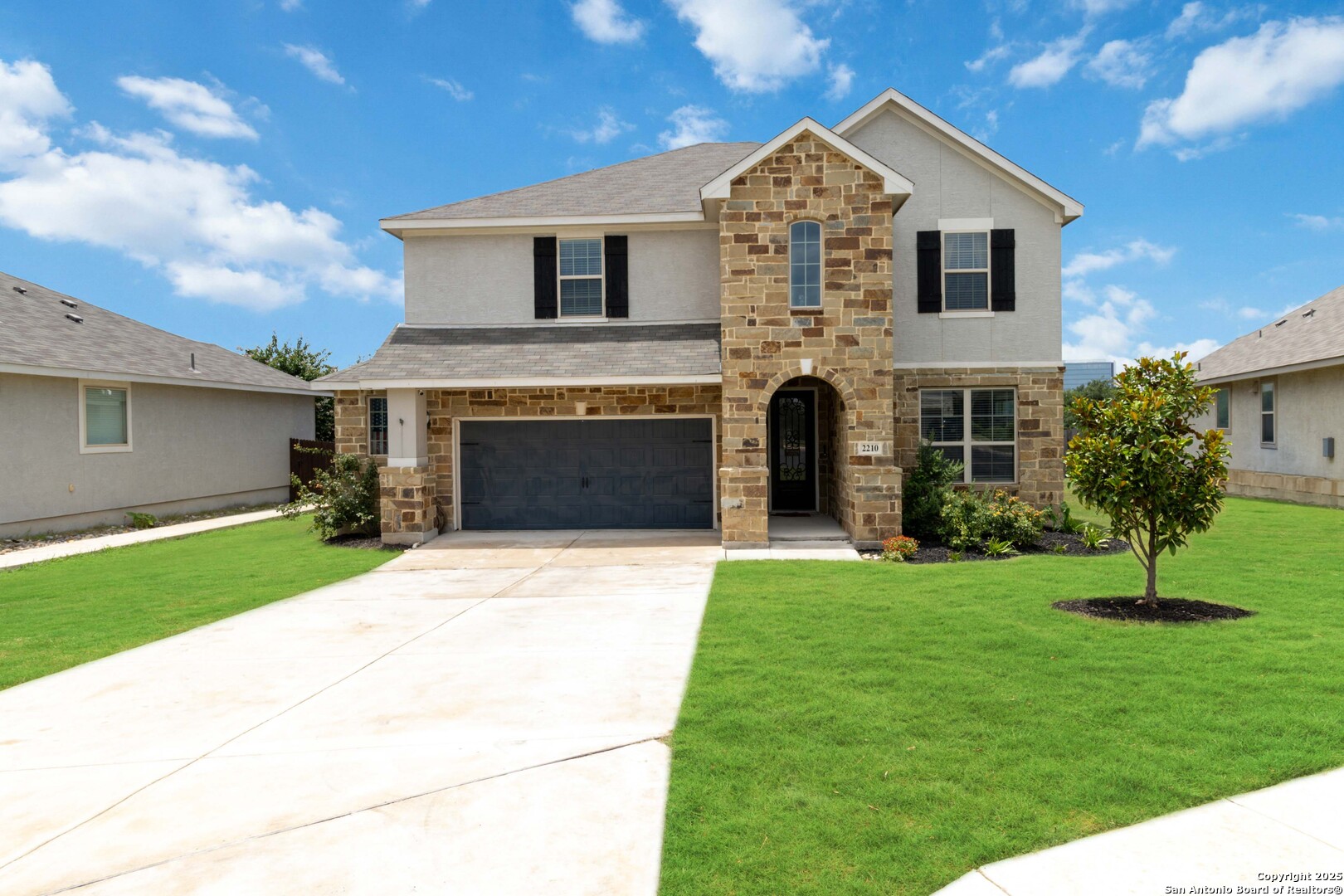 2210 Castello Way San Antonio, TX 78259 - Photo 1 of 48 a front view of a house with a yard and garage