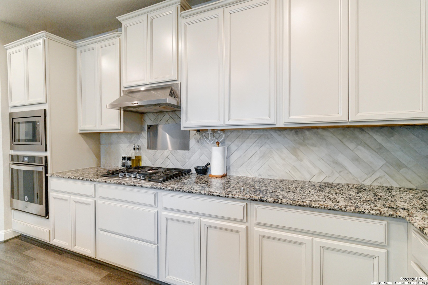 2210 Castello Way San Antonio, TX 78259 - Photo 14 of 48 a kitchen with granite countertop white cabinets and a sink
