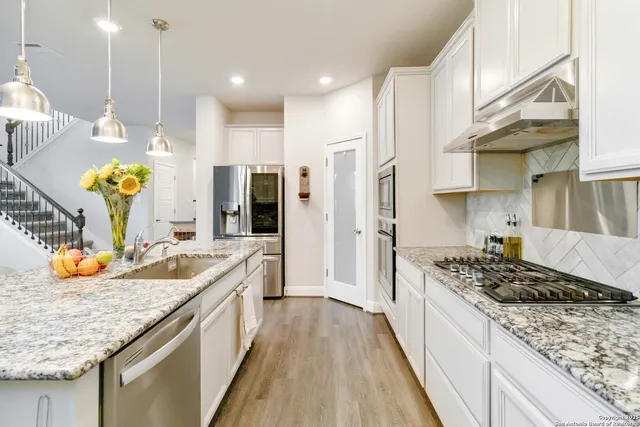 a kitchen with a sink stove and refrigerator