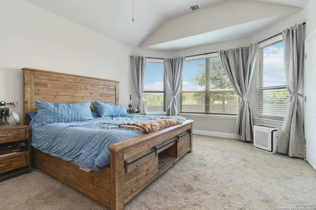 a bed sitting in a room next to a window