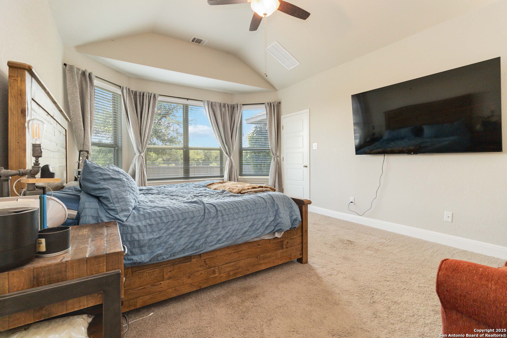 2210 Castello Way San Antonio, TX 78259 - Photo 19 of 48 a spacious bedroom with a large bed and a flat screen tv