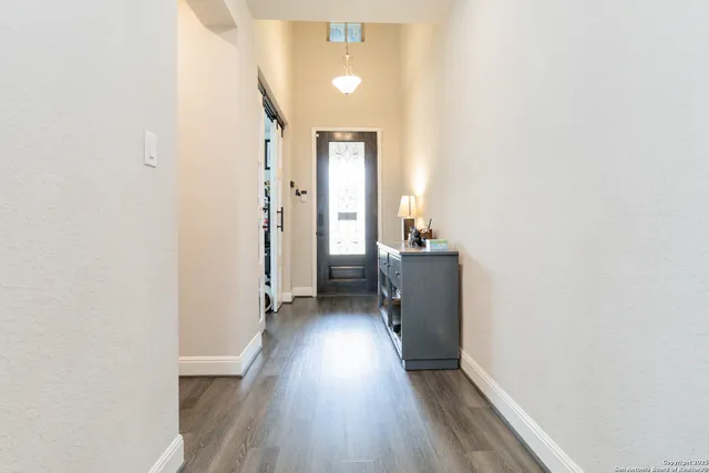 a view of hallway with wooden floor