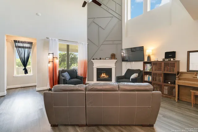 a living room with furniture wooden floor and a fireplace