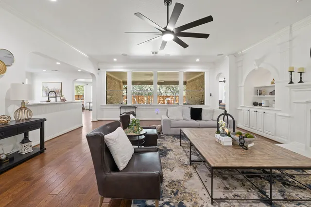 a living room with fireplace furniture and a wooden floor