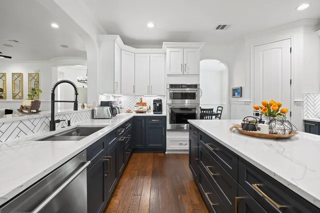 a kitchen with sink a stove and cabinets