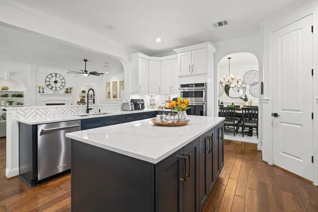 a kitchen with a sink a stove and cabinets