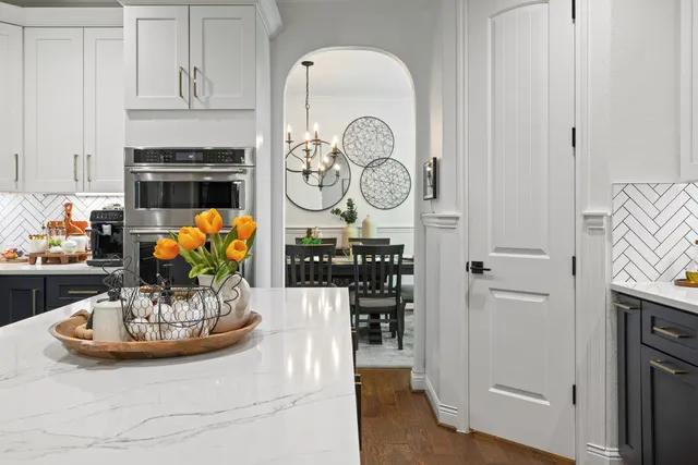 a kitchen with a refrigerator and a stove top oven