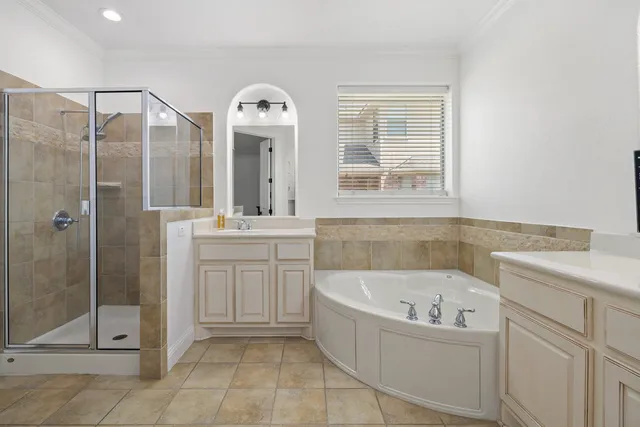 a bathroom with a bathtub sink and mirror