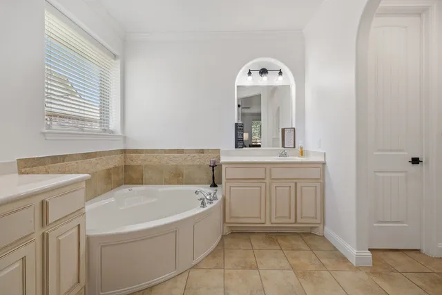a bathroom with a bathtub sink and a mirror