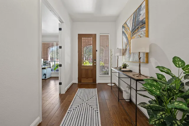 a view of a hallway view with wooden floor and furniture