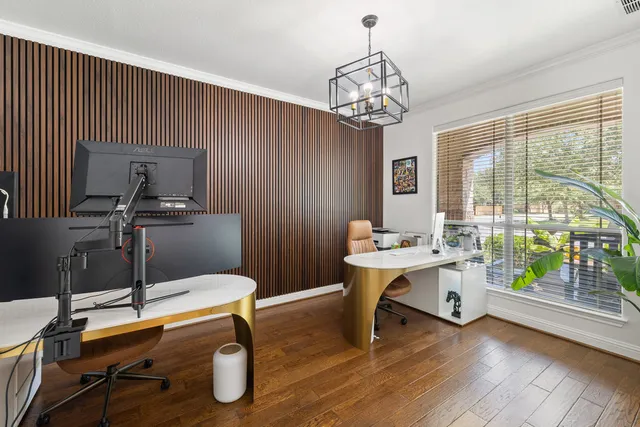 a view of a workspace with furniture window and wooden floor