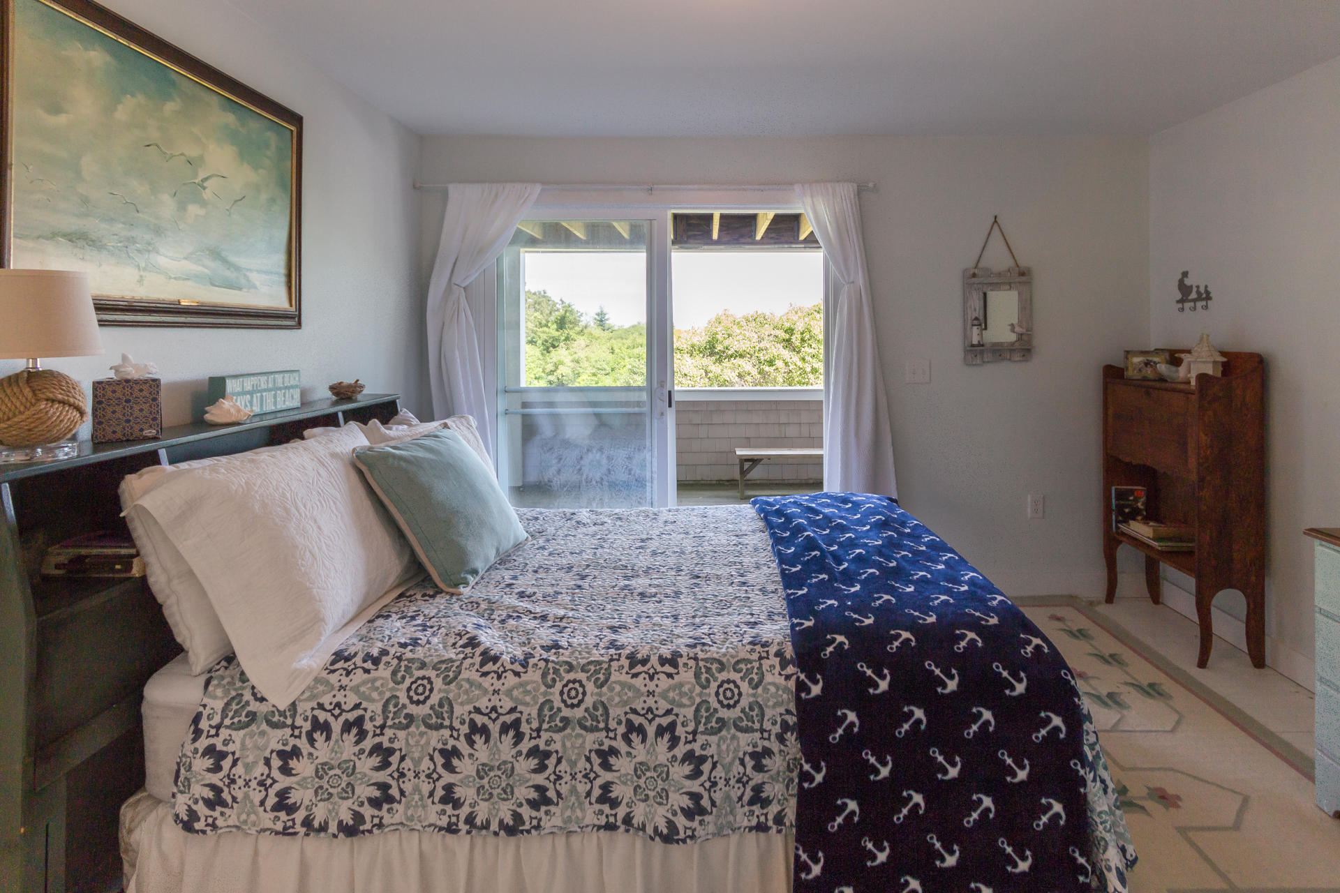 10 Calebs Pond Road Edgartown, MA 02539 - Photo 23 of 26 a bedroom with a bed window and a table