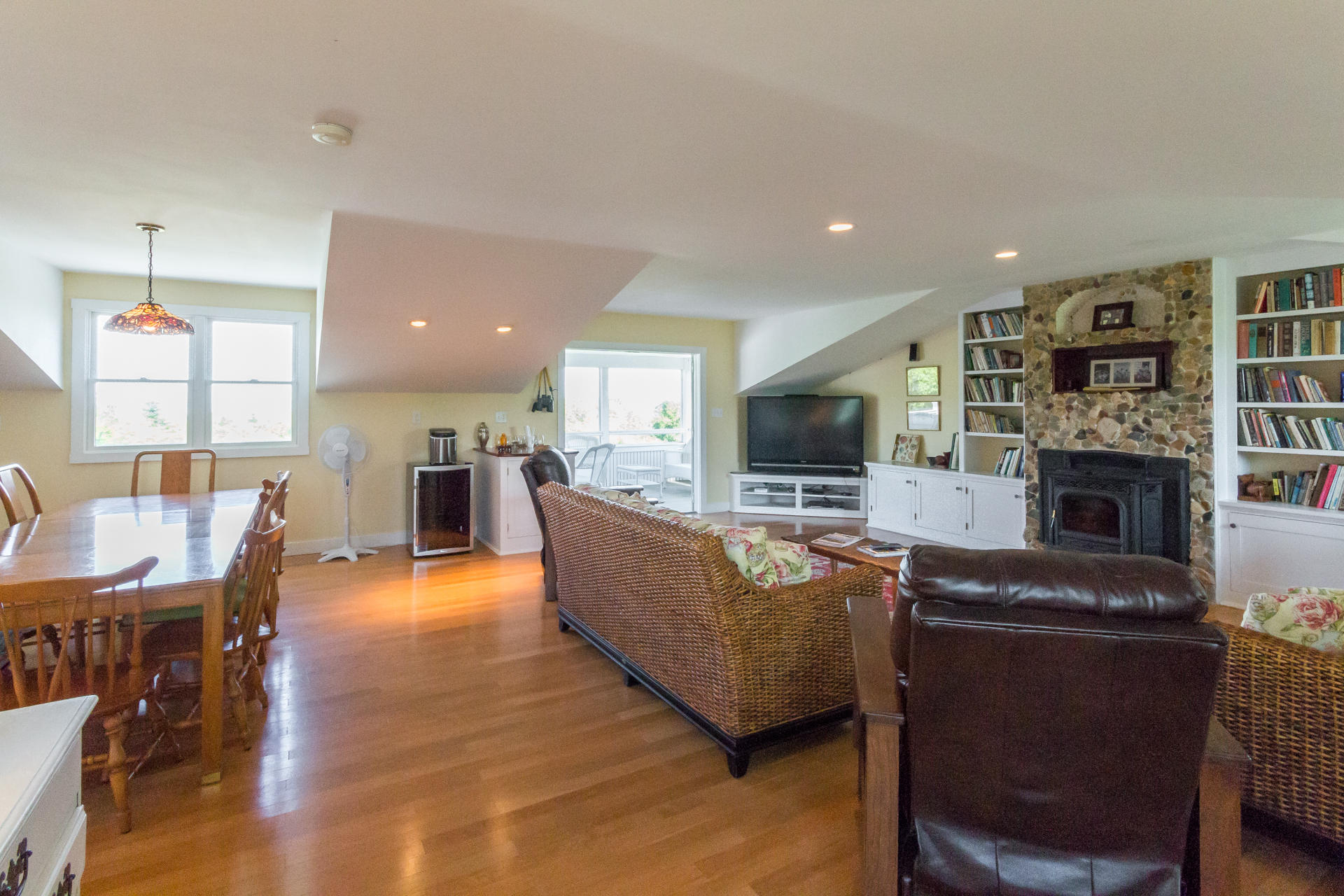 10 Calebs Pond Road Edgartown, MA 02539 - Photo 4 of 26 a living room with furniture a flat screen tv and a fireplace