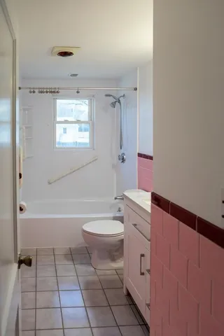 a bathroom with a granite countertop toilet a sink and bathtub