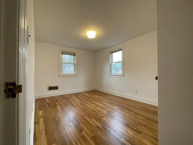 an empty room with windows and closet