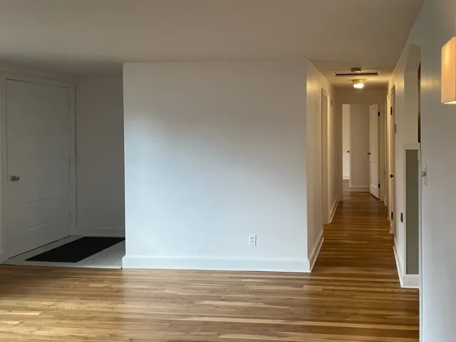 a view of a room with wooden floor