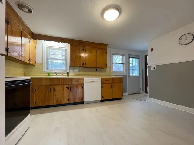 a kitchen with stainless steel appliances a stove sink and cabinets