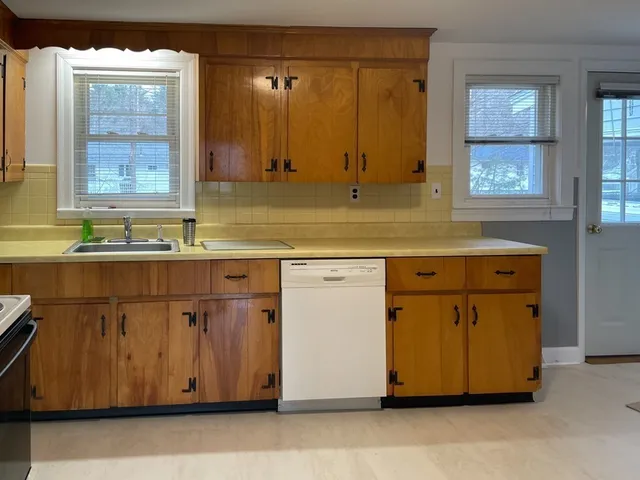 a kitchen with stainless steel appliances granite countertop a sink and a stove