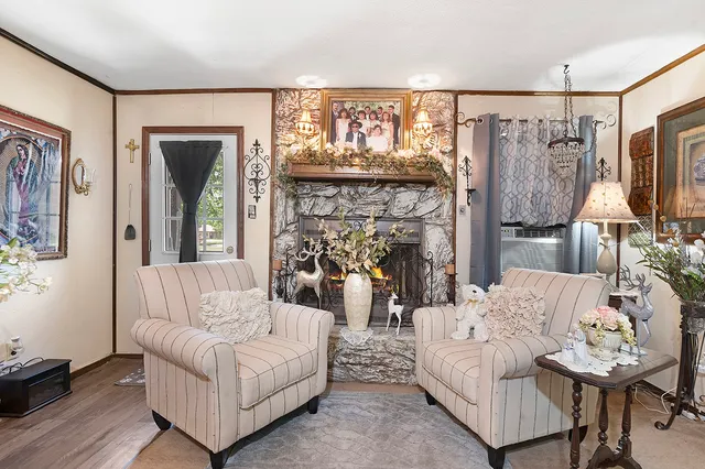 a living room with furniture a fireplace and a flat screen tv