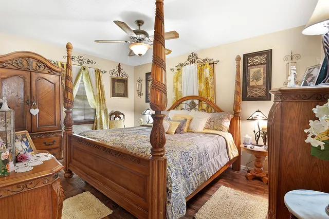 a bedroom with a bed and wooden cabinets