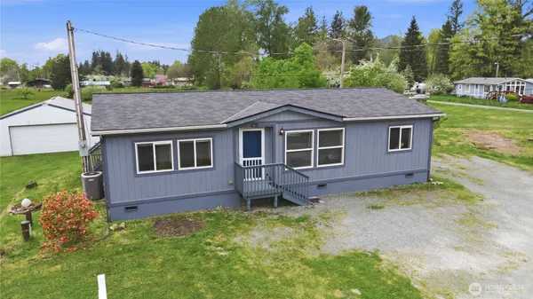 a aerial view of a house with a garden and trees