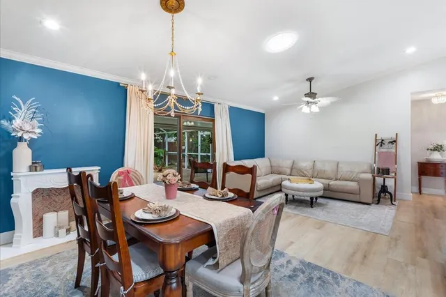 a dining room with furniture a chandelier and window