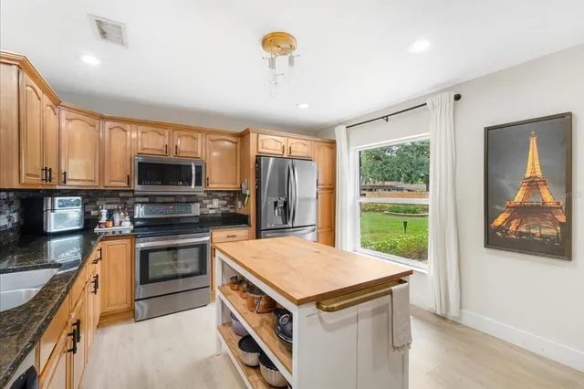 a kitchen with a stove a sink and a refrigerator