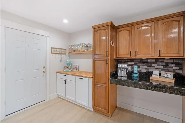 a kitchen with stainless steel appliances granite countertop a refrigerator and a stove top oven