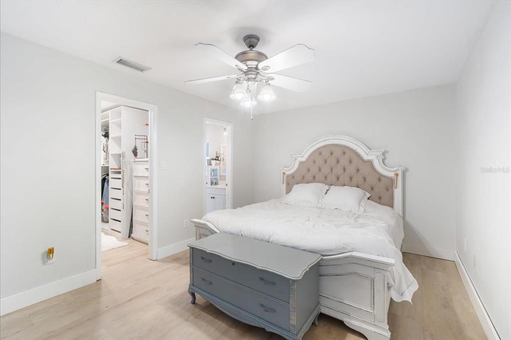 15911 Ironware Place Tampa, FL 33624 - Photo 16 of 31 a bedroom with a bed and a chandelier