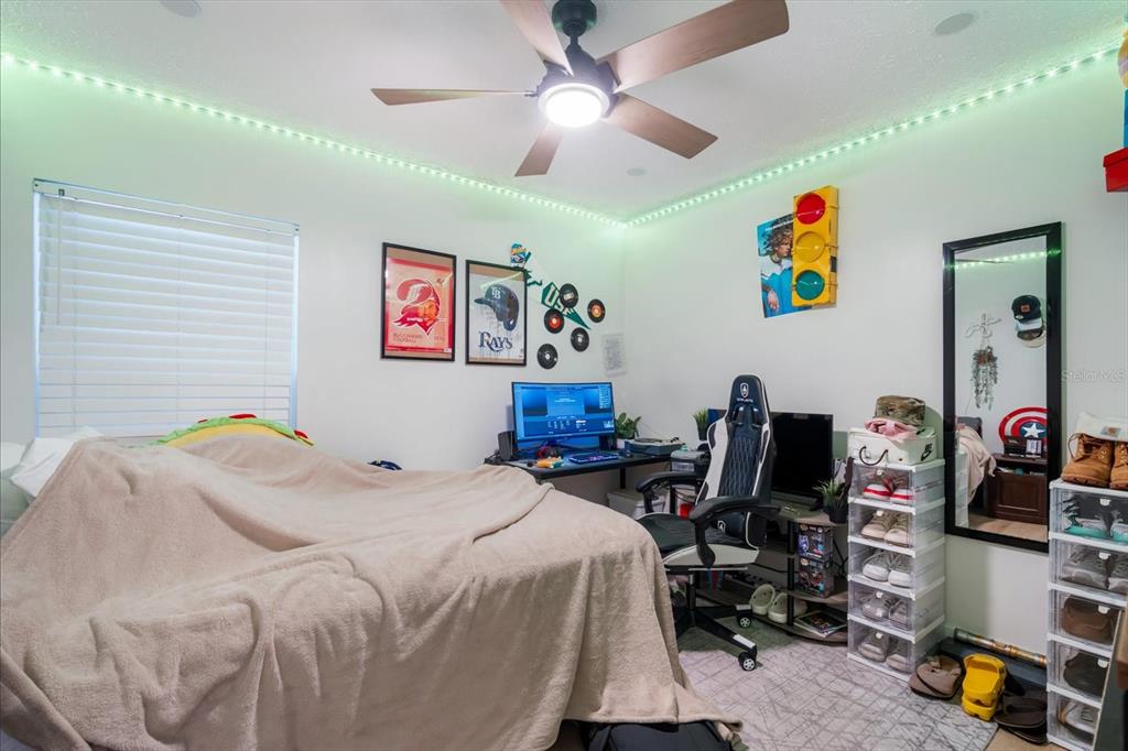 15911 Ironware Place Tampa, FL 33624 - Photo 21 of 31 a bedroom with a bed and furniture