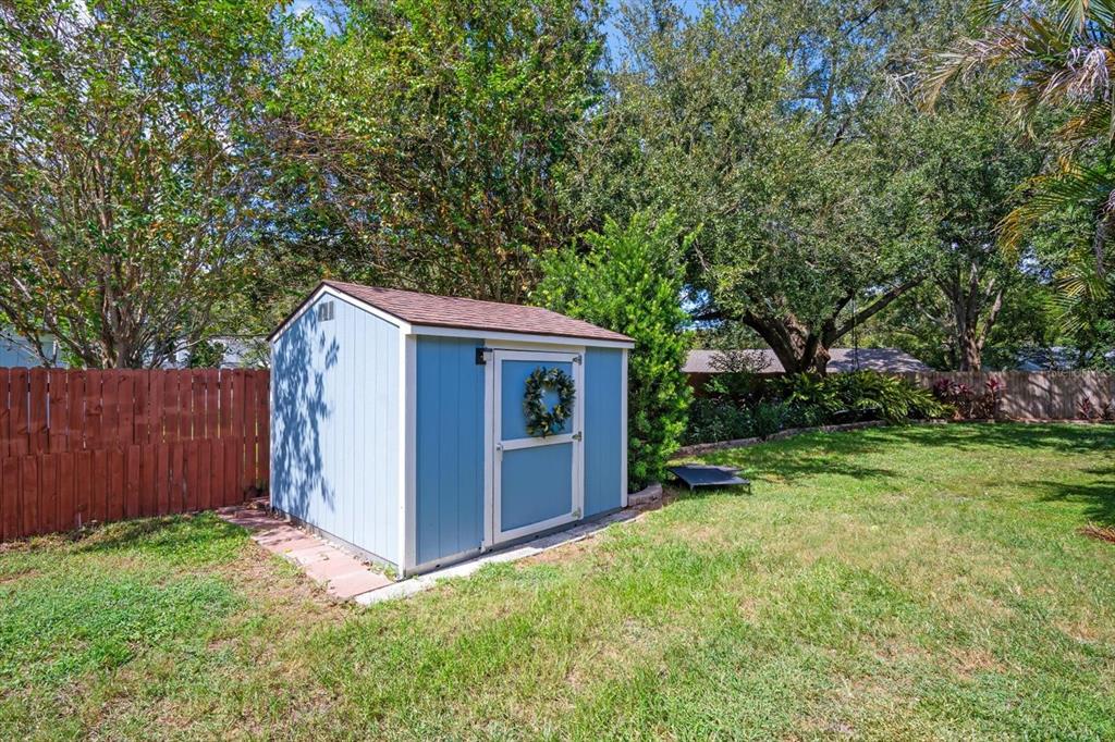 15911 Ironware Place Tampa, FL 33624 - Photo 26 of 31 a view of an house with backyard space and garden