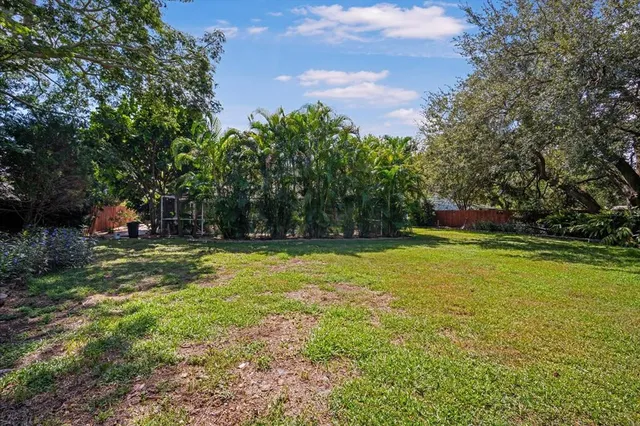 a view of outdoor space with swimming pool and green space