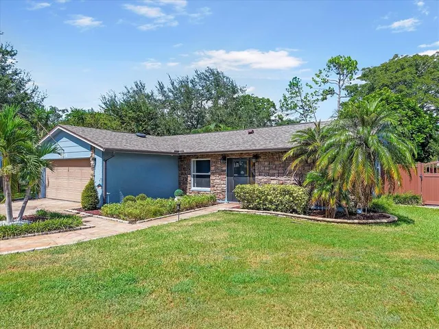 a front view of house with yard and green space