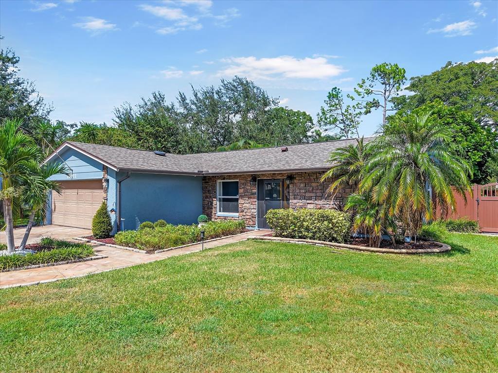 15911 Ironware Place Tampa, FL 33624 - Photo 3 of 31 a front view of house with yard and green space