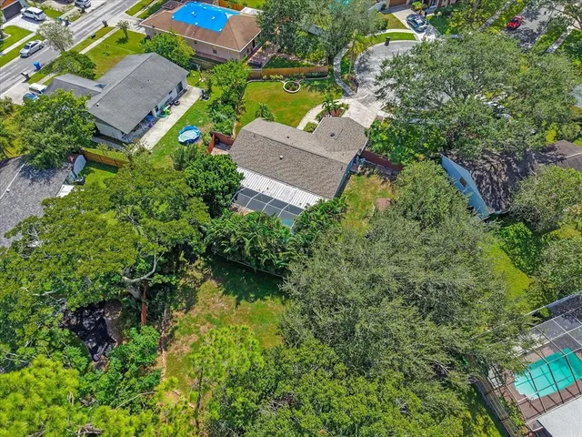 an aerial view of a house with garden space and street view