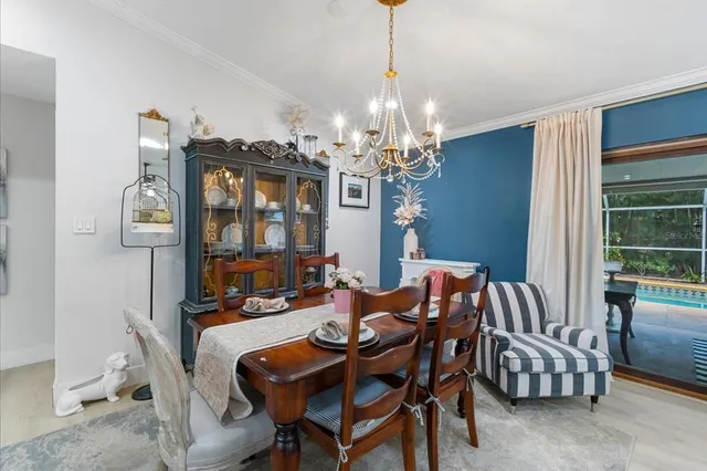 a dining room with furniture a chandelier and window