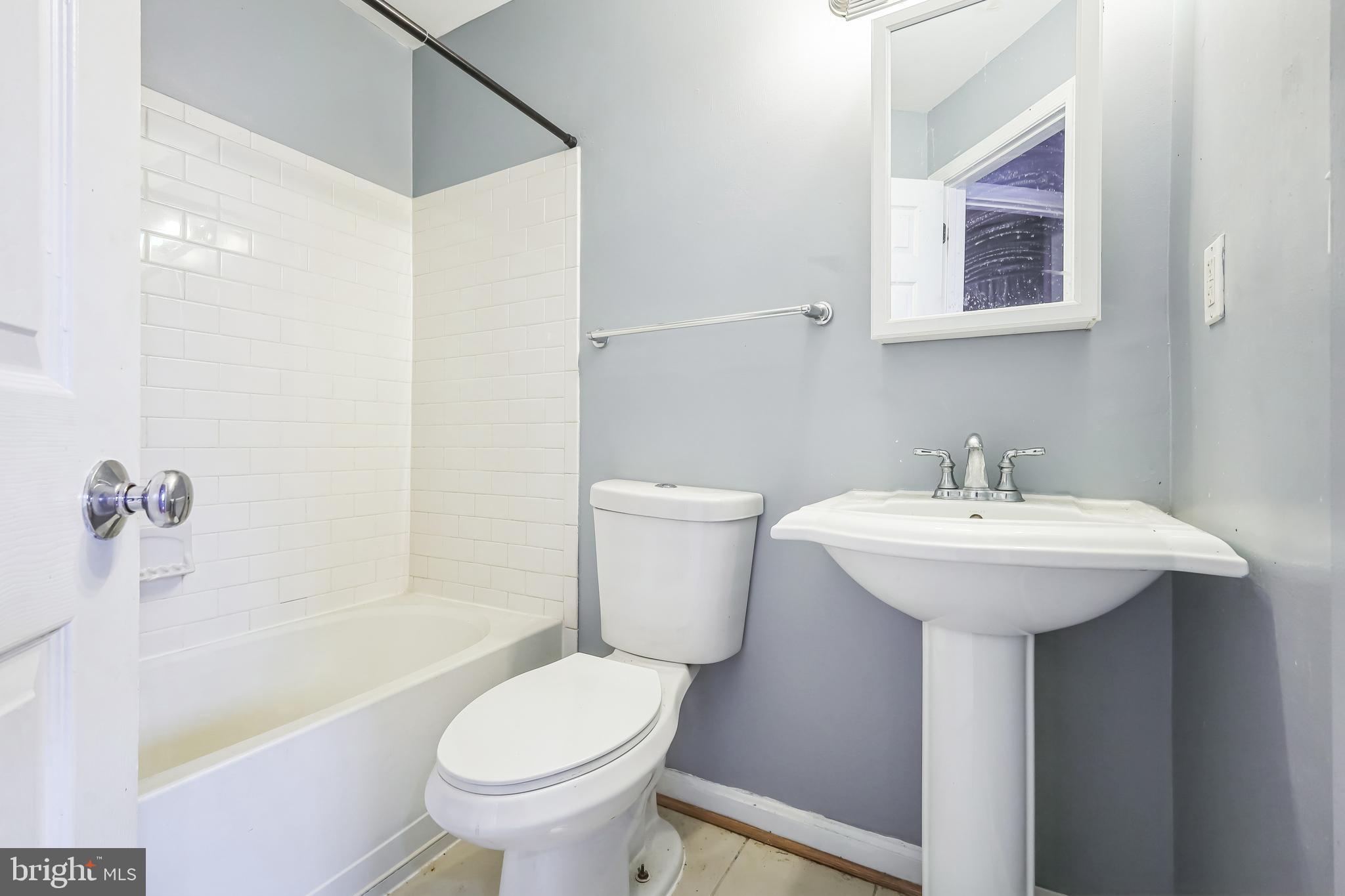 610 Irving Street Northwest, Unit 105 Washington, DC 20010 - Photo 13 of 28 a bathroom with a sink toilet and shower