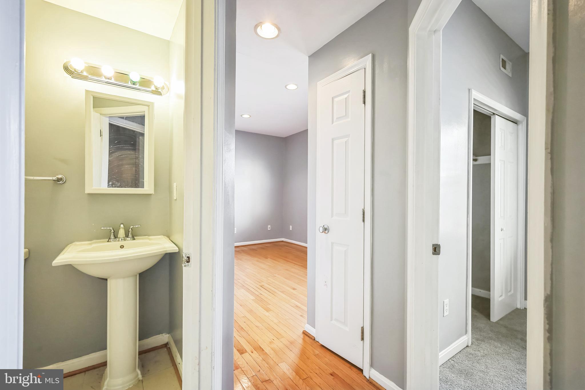 610 Irving Street Northwest, Unit 105 Washington, DC 20010 - Photo 14 of 28 a bathroom with a sink and a mirror