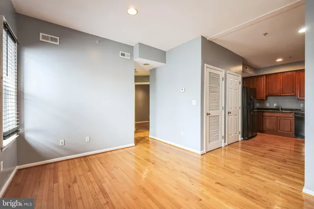 a view of a kitchen with a sink and a refrigerator