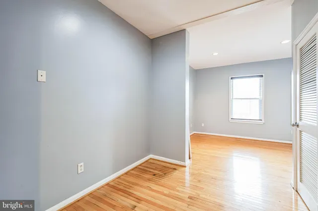 a view of a room with wooden floor and a window