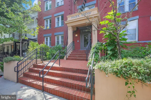 a view of a house with potted plants