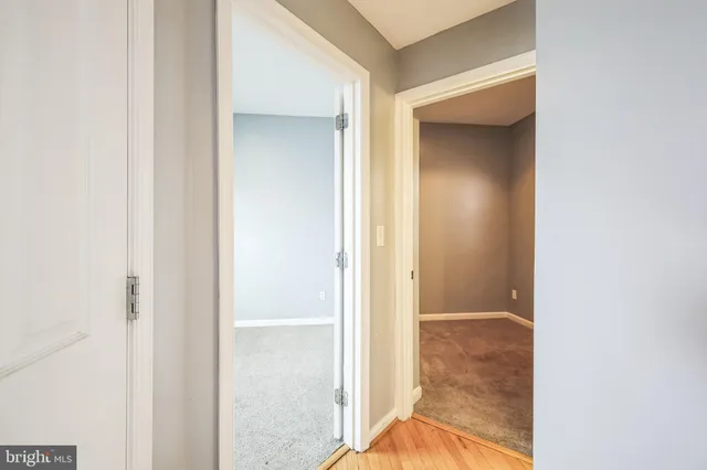 a view of a bathroom from a corridor