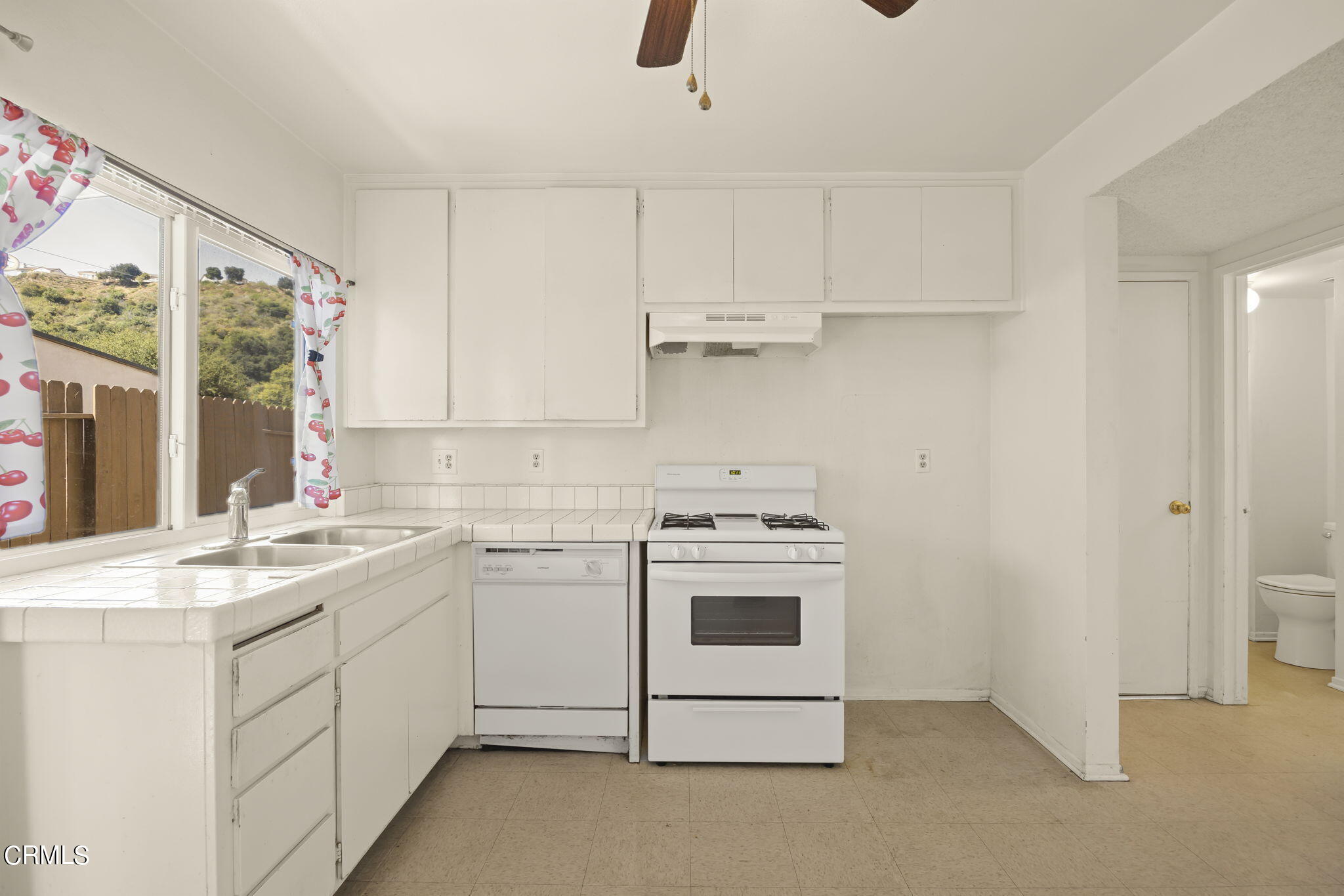 1106 Ojai Road Santa Paula, CA 93060 - Photo 13 of 45 a kitchen with appliances cabinets and a sink