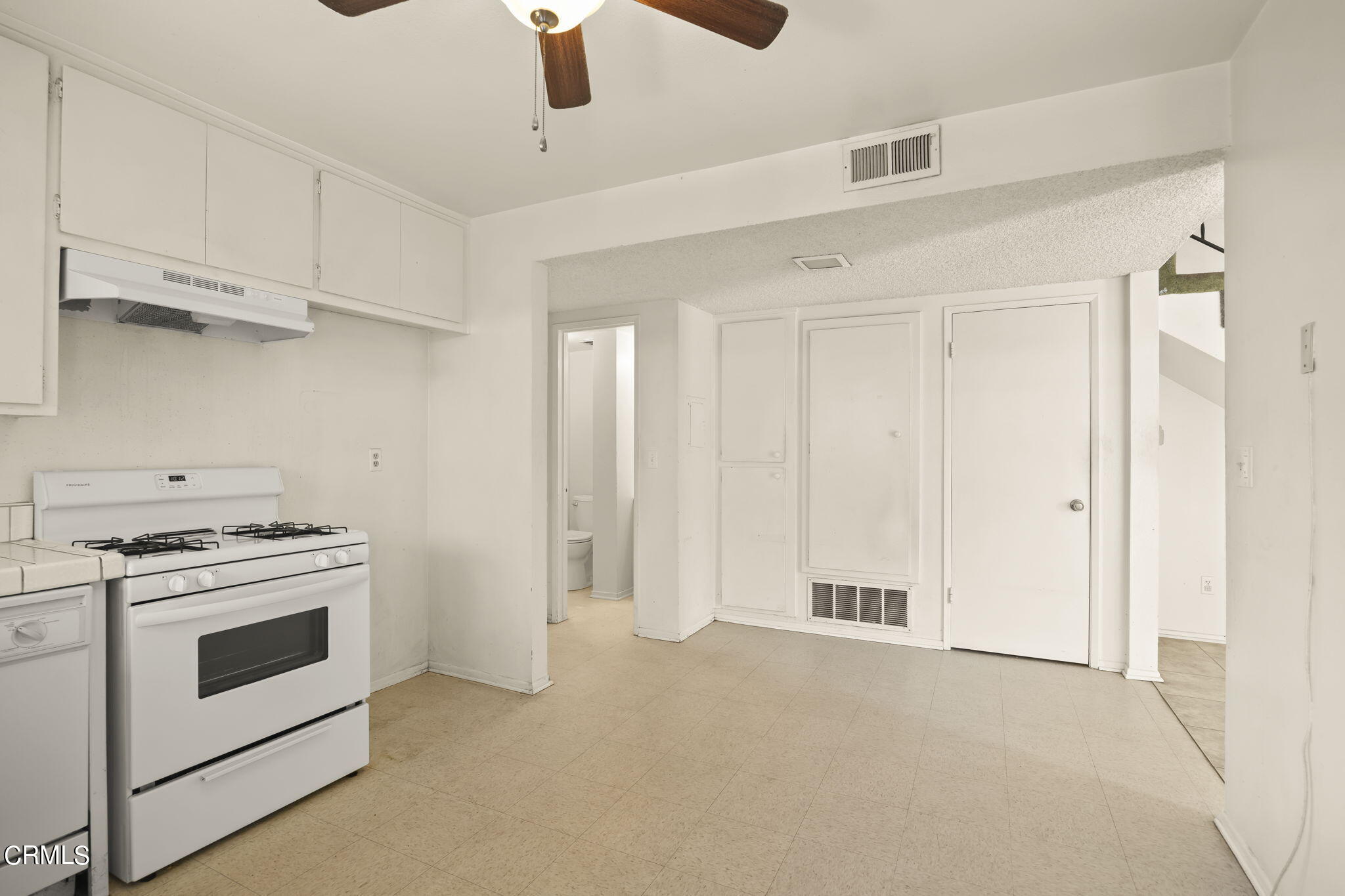 1106 Ojai Road Santa Paula, CA 93060 - Photo 14 of 45 a open kitchen with white cabinets and white appliances