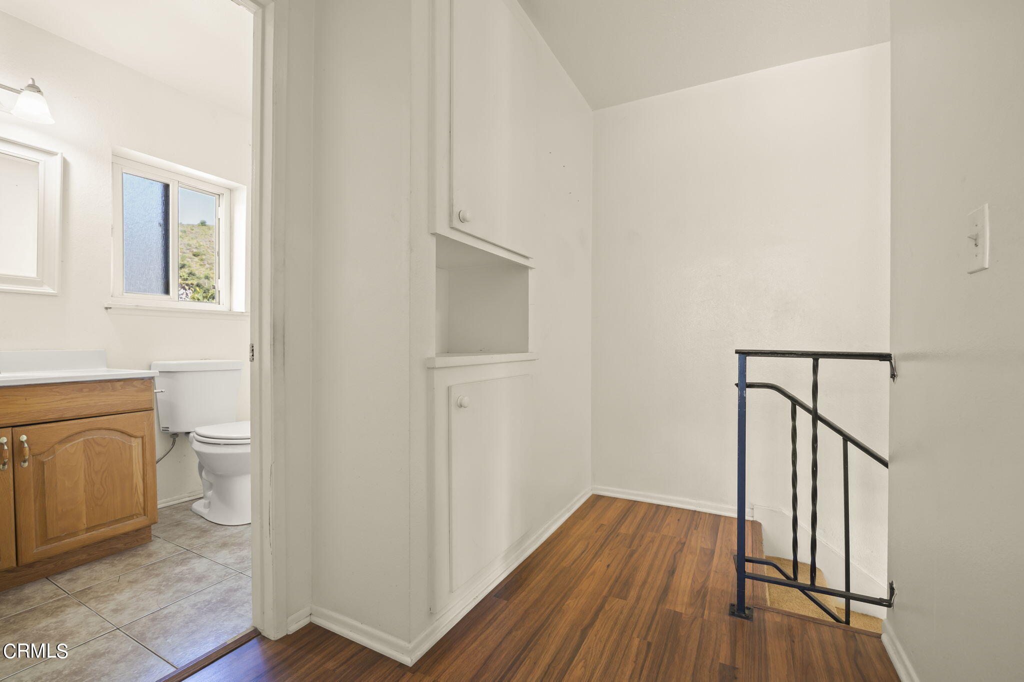 1106 Ojai Road Santa Paula, CA 93060 - Photo 20 of 45 a view of a hallway with wooden floor and bathroom