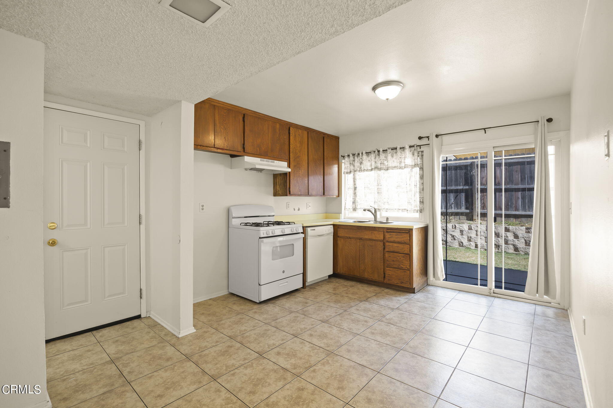1106 Ojai Road Santa Paula, CA 93060 - Photo 29 of 45 a kitchen with stainless steel appliances a stove sink and cabinets