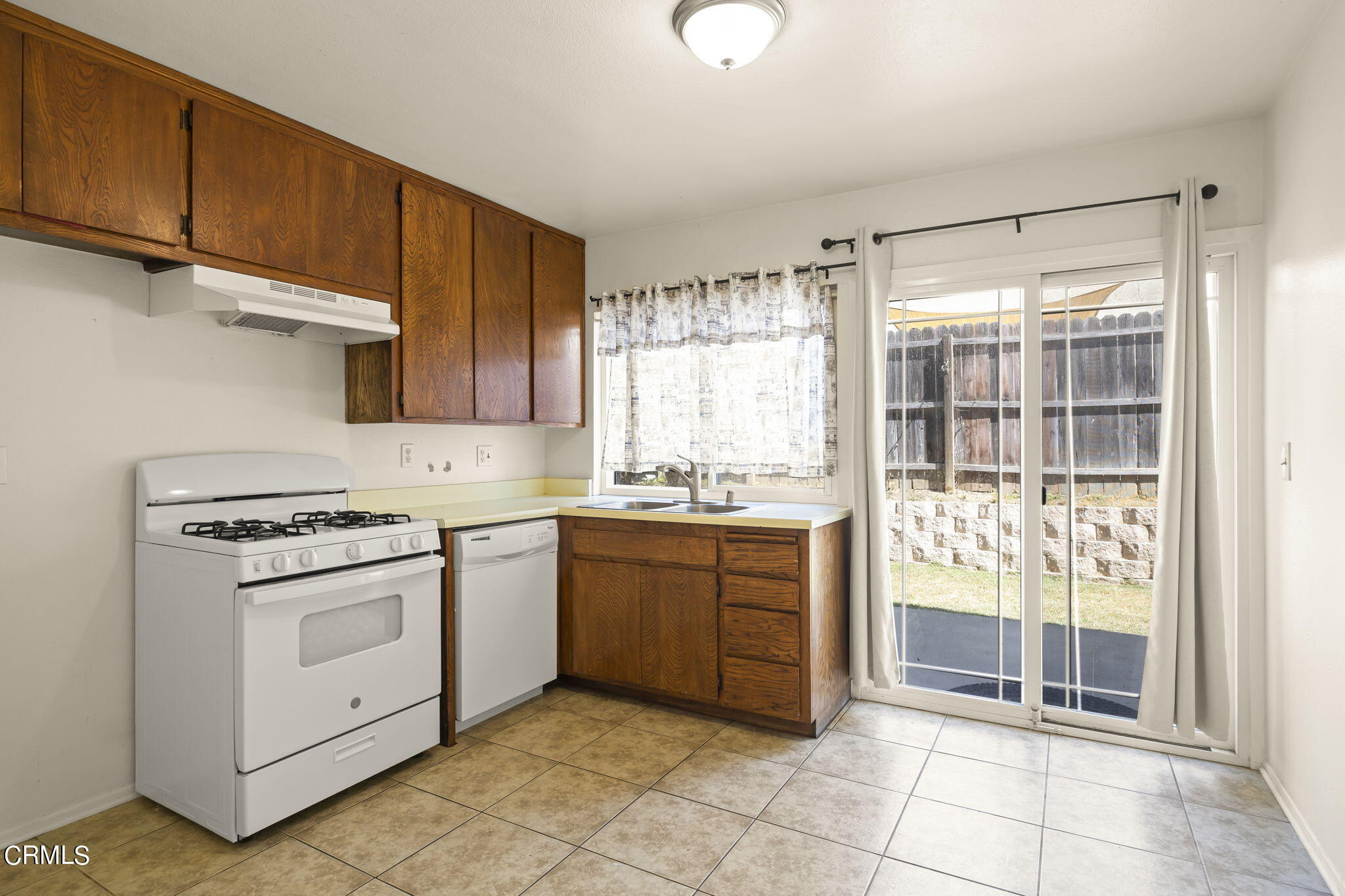 1106 Ojai Road Santa Paula, CA 93060 - Photo 30 of 45 a kitchen with a stove a sink and a refrigerator