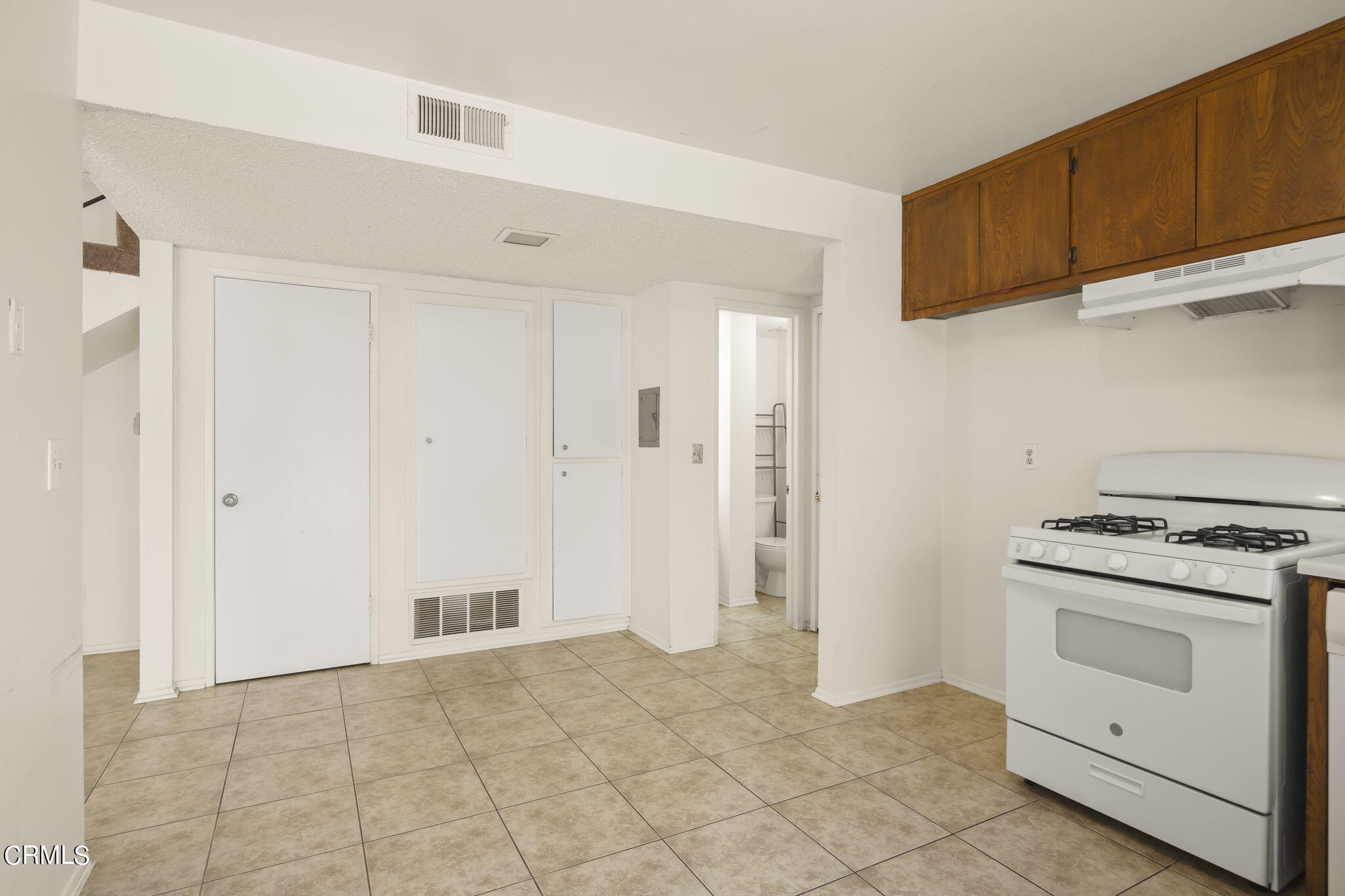 1106 Ojai Road Santa Paula, CA 93060 - Photo 31 of 45 a kitchen with white cabinets and white appliances