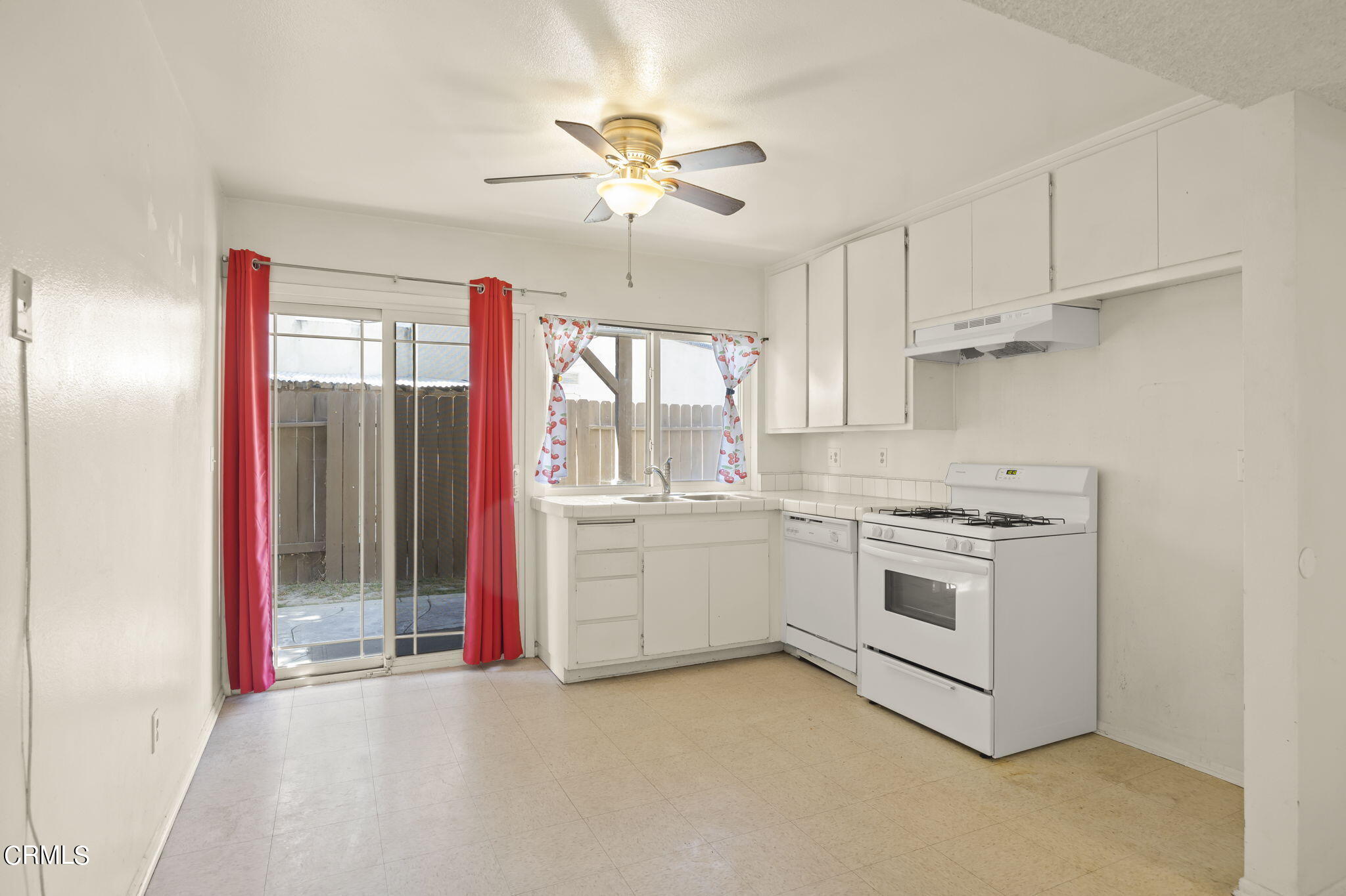 1106 Ojai Road Santa Paula, CA 93060 - Photo 10 of 45 a kitchen with granite countertop white cabinets and white appliances