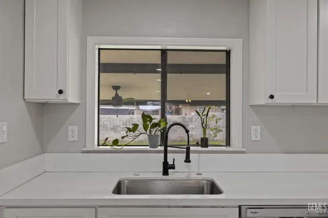 a kitchen with granite countertop wooden floors and stainless steel appliances